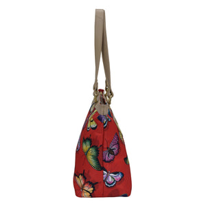 An Anuschka Fabric with Leather Trim Zip Top City Tote - 12005 with a butterfly print design and a leather shoulder strap.
