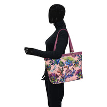 Load image into Gallery viewer, Mannequin with an Anuschka Fabric with Leather Trim Zip Top City Tote - 12005 on its shoulder, featuring a leather shoulder strap.
