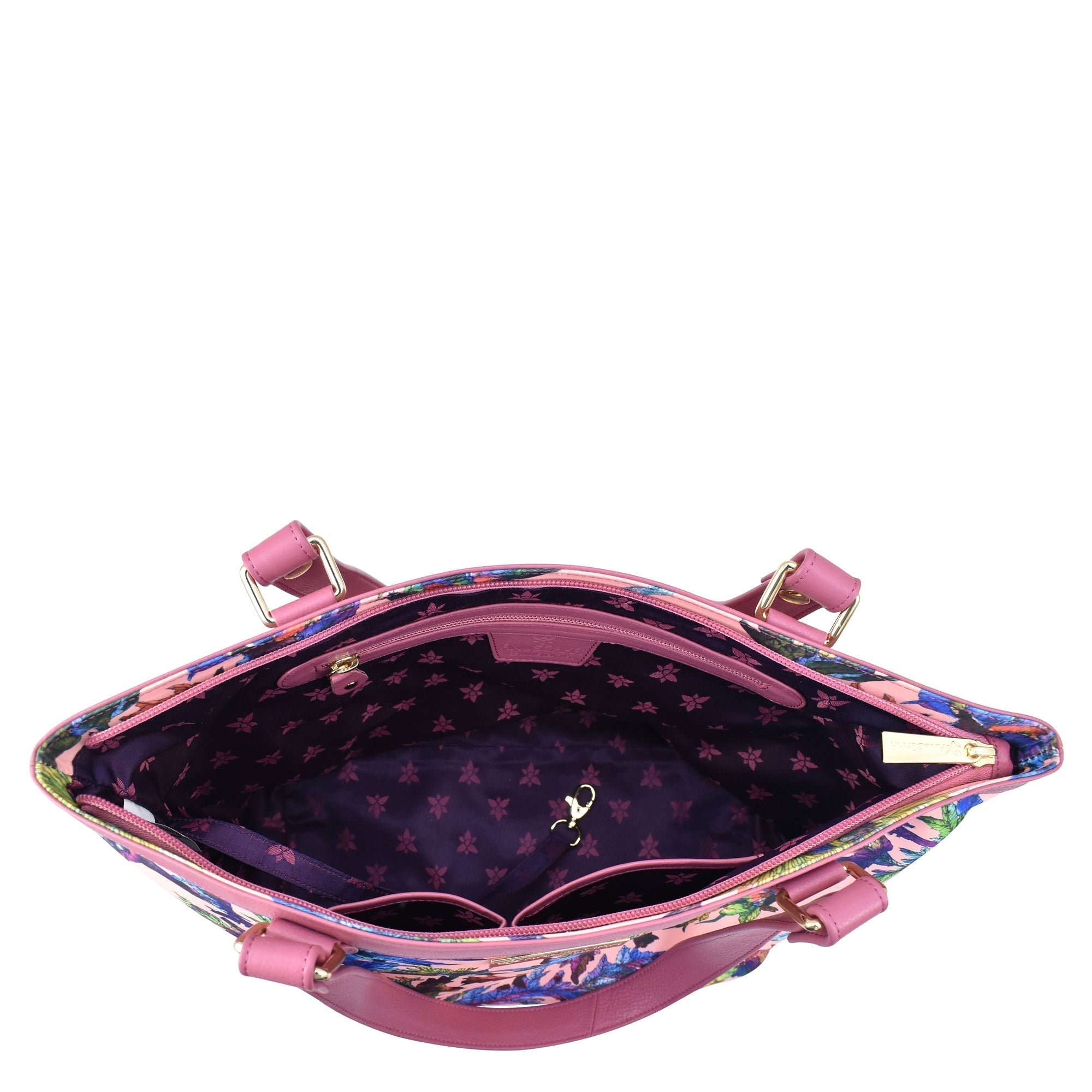 Open Anuschka handbag displaying the interior, patterned lining, and a zippered pocket.