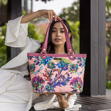 Load image into Gallery viewer, A woman showcasing a colorful floral Anuschka Fabric with Leather Trim Zip Top City Tote - 12005.
