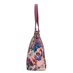 Colorful floral print Anuschka handbag with a leather shoulder strap.
