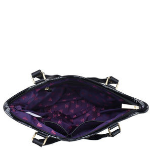 Open Anuschka Fabric with Leather Trim Zip Top City Tote -12005 handbag with a purple interior and a pattern of stars, featuring a zip entry and a leather shoulder strap.