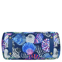 Load image into Gallery viewer, Patterned clutch with marine shell design, navy blue accents, and zip entry by Anuschka.
