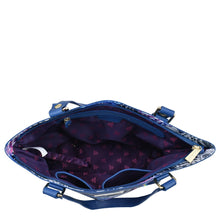 Load image into Gallery viewer, An open, empty Anuschka Fabric with Leather Trim Zip Top City Tote - 12005 in blue with a star-patterned interior and a leather shoulder strap isolated on a white background.
