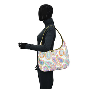 Mannequin wearing a paisley patterned Fabric with Leather Trim Large Sling Hobo - 12010 by Anuschka with zippered pockets.