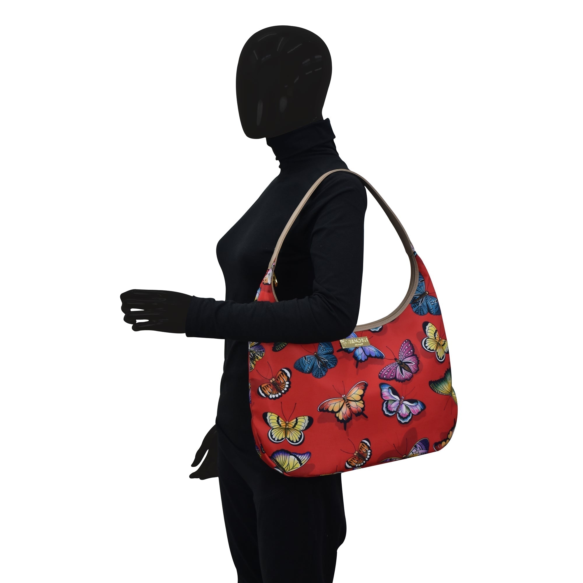 Mannequin with an Anuschka Fabric with Leather Trim Large Sling Hobo - 12010 featuring zippered pockets on white background.