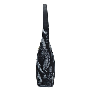 Anuschka Fabric with Leather Trim Large Sling Hobo - 12010 bag with a floral print design against a white background, featuring a zippered pocket.