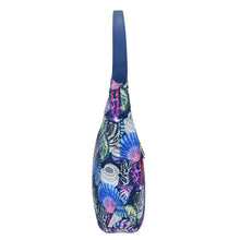 Load image into Gallery viewer, Colorful printed Anuschka sling bag with a zippered pocket on a white background.
