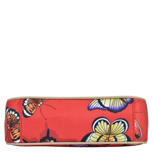 Anuschka's Floral-patterned red wallet with a zippered wall pocket, on a white background.