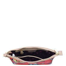 Load image into Gallery viewer, Open Anuschka handbag with visible interior detail and a zippered wall pocket, isolated on a white background.
