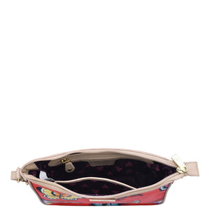 Open Anuschka handbag with visible interior detail and a zippered wall pocket, isolated on a white background.