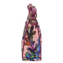 Load image into Gallery viewer, Side view of a floral-patterned, pink strap Anuschka handbag with a buckle detail and an adjustable handle drop.
