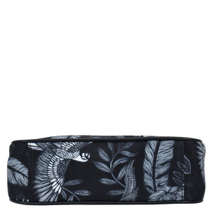 Black Anuschka cosmetic bag with white tropical print design, featuring a zippered wall pocket.