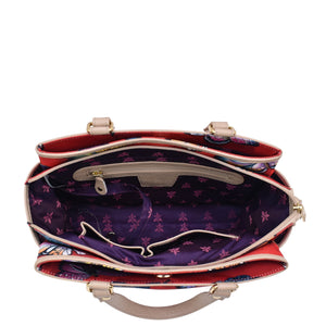 An Anuschka Fabric with Leather Trim Multi Compartment Satchel - 12014 with a patterned interior, multiple compartments, and an adjustable strap.