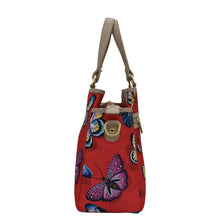 Load image into Gallery viewer, Anuschka&#39;s Fabric with Leather Trim Multi Compartment Satchel - 12014, with a colorful butterfly pattern and an adjustable cream strap.
