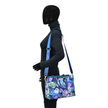 Load image into Gallery viewer, Mannequin displaying an Anuschka Fabric with Leather Trim Multi Compartment Satchel - 12014 with a floral pattern and an adjustable strap.
