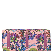 Load image into Gallery viewer, Floral patterned clutch bag with pink background, brass-toned hardware, and a crossbody strap by Anuschka.
