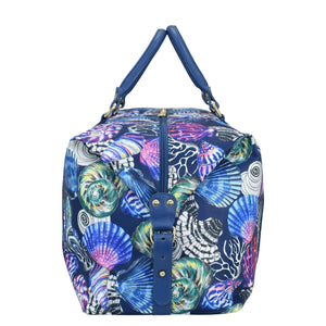 Colorful marine-themed print Anuschka handbag with blue handles and a crossbody strap.