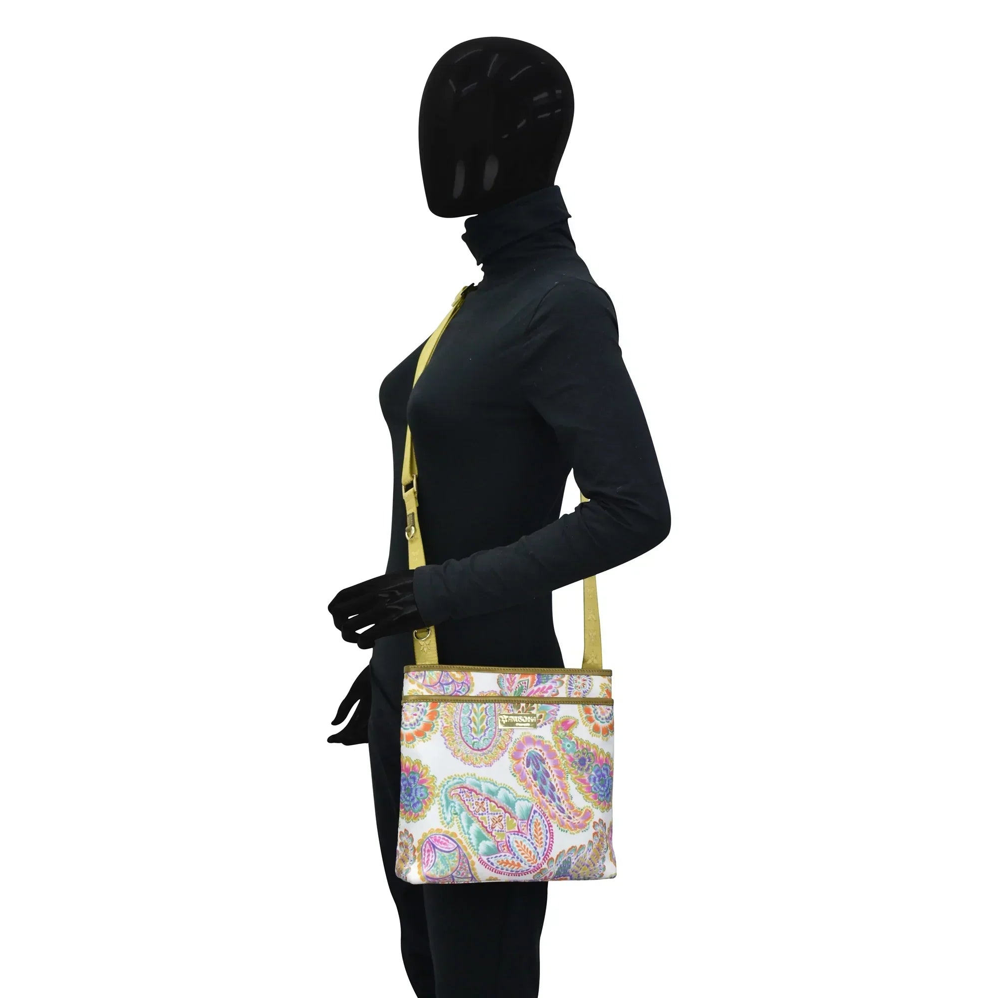 Mannequin with black bodysuit and full head covering holding an Anuschka Fabric with Leather Trim Crossbody with Slip Pocket - 12017.