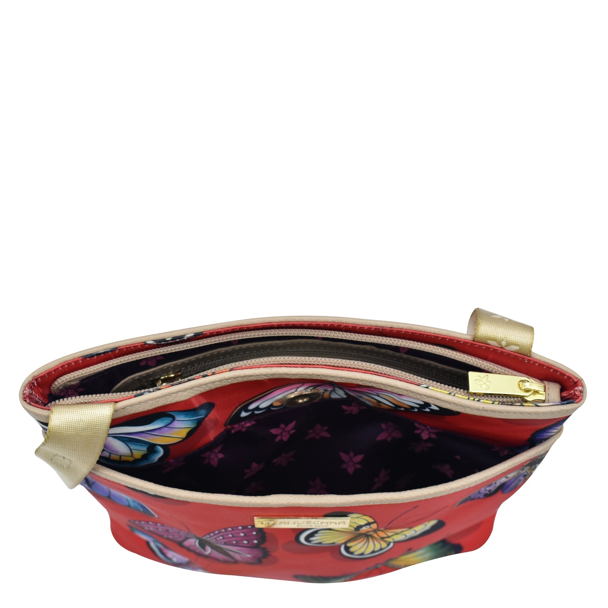 An open red Fabric with Leather Trim Crossbody with Slip Pocket - 12017 pouch with a floral interior and a gold zipper, featuring an adjustable handle by Anuschka.