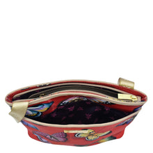 Load image into Gallery viewer, An open red Fabric with Leather Trim Crossbody with Slip Pocket - 12017 pouch with a floral interior and a gold zipper, featuring an adjustable handle by Anuschka.
