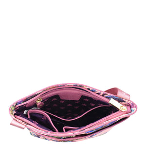 An Anuschka open pink purse with a star-patterned interior and an adjustable handle, isolated on a white background.