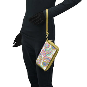 Person in a black outfit carrying an Anuschka RFID protected, patterned Fabric with Leather Trim Wristlet Travel Wallet - 13000 with zip entry.