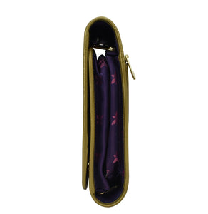 Open Anuschka mustard-colored fabric with leather trim toiletry case - 13001 with a purple interior visible, featuring zippered pockets.