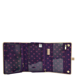 Open Anuschka women's wallet with multiple compartments, a purple floral pattern, and zippered pockets.