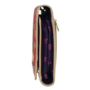 Side view of a partially open, colorful zippered Anuschka toiletry case with leather trim, zippered pockets, displaying its content and lining.