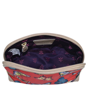 Open Anuschka fabric with leather trim dome cosmetic bag with a zip entry and a floral interior design.