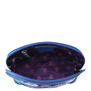 Open empty Anuschka Fabric with Leather Trim Dome Cosmetic Bag - 13002 with a floral pattern interior and full length zippered pocket, isolated on a white background.