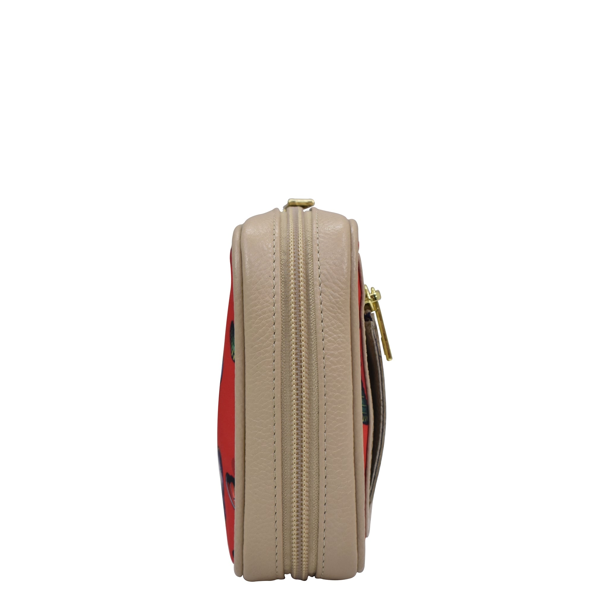 Side view of a beige Anuschka wallet with a patterned interior and gold-tone zip entry hardware.