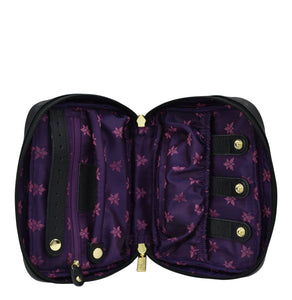 Open Anuschka black wallet with purple floral interior and zippered wall pocket.
