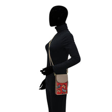 Load image into Gallery viewer, Mannequin showcasing a black outfit and a small Anuschka Fabric with Leather Trim Cell Phone Crossbody Wallet - 13005 with a floral pattern and RFID protection.
