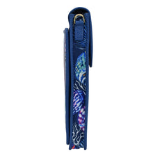 Load image into Gallery viewer, Side view of a rolled-up Anuschka blue yoga mat with a patterned design and crossbody strap.
