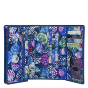 An Anuschka Fabric with Leather Trim Three-Fold RFID Wallet - 13007 with multiple card slots and a zipper compartment.