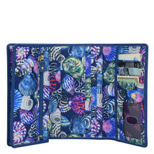 Load image into Gallery viewer, An Anuschka Fabric with Leather Trim Three-Fold RFID Wallet - 13007 with multiple card slots and a zipper compartment.
