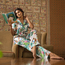 Load image into Gallery viewer, Woman sitting on a couch reading a book, wearing Anuschka&#39;s colorful, patterned Pajama Set - 3344 made from recycled fabric.
