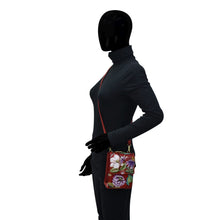 Load image into Gallery viewer, Mannequin displaying a Anuschka Triple Compartment Crossbody Organizer - 412 with hand-painted floral design against a plain background.

