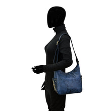 Load image into Gallery viewer, Mannequin dressed in black with an Anuschka Classic Hobo With Studded Side Pockets - 433.
