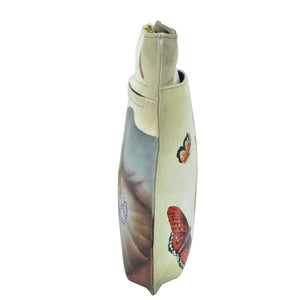 Decorative Anuschka vase with hand-painted butterfly motifs on a white background.