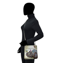 Load image into Gallery viewer, Mannequin with an Anuschka Slim Crossbody With Front Zip - 452 tote bag featuring hand painted artwork.
