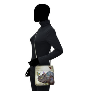 Mannequin with an Anuschka Slim Crossbody With Front Zip - 452 tote bag featuring hand painted artwork.