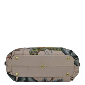 Beige hand-painted Anuschka Triple Compartment Satchel - 469 with gold-tone hardware on a plain background, featuring a zippered pocket.