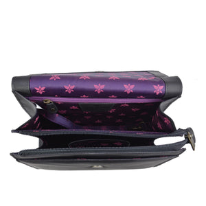 Open Anuschka black leather wallet with purple interior and a floral pattern.