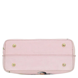 Pale pink leather Anuschka tote bag with gold-tone stud details and zippered compartments.