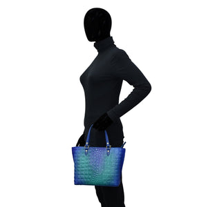 Sentence with replaced product: Silhouetted figure holding an Anuschka Medium Tote - 693.