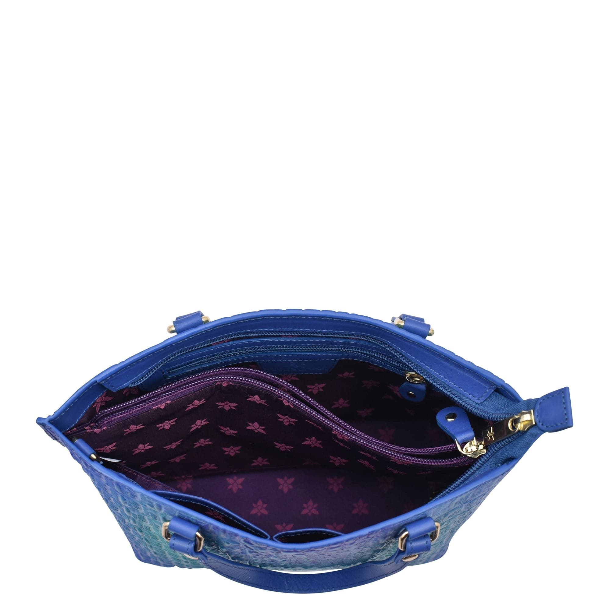 An open blue leather Medium Tote - 693 by Anuschka isolated on a white background showing the interior fabric pattern.