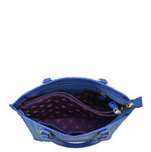 Load image into Gallery viewer, An open blue leather Medium Tote - 693 by Anuschka isolated on a white background showing the interior fabric pattern.
